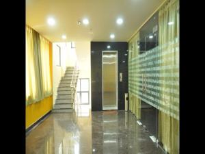 a hallway with a staircase in a building at Hotel Sri Hasmitha in Vijayawāda