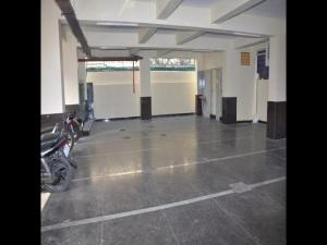 a empty parking lot with a motorcycle parked in it at Hotel Sri Hasmitha in Vijayawāda +4 photos