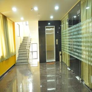 a hallway with a staircase in a building at Hotel Sri Hasmitha in Vijayawāda