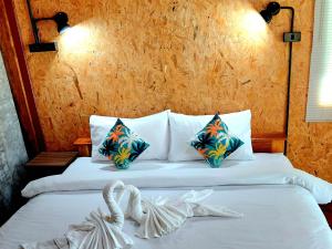a bedroom with a bed with two towels on it at Nathan Breeze Resort in Ko Muk