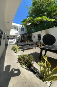a shadow of a person taking a picture of a patio at The Hostal Inn in Playa del Carmen