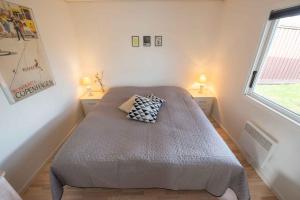 a bedroom with a bed in a room with a window at Cottage With Panoramic View Of Lammefjorden in Holbæk
