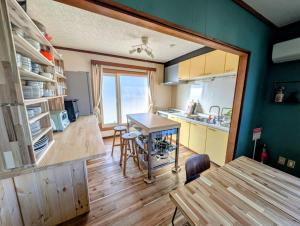 a kitchen and dining room with a table and chairs at Migiwa House in Rankoshi