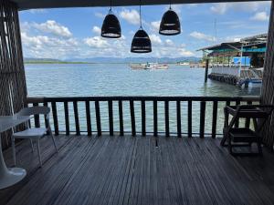 a porch with a view of a body of water at Kthorm Nesat Koh Kong in Phumĭ Stœ̆ng Vêng