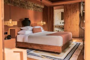 a bedroom with a large bed in a room at Sana Vie Villa Seminyak by Ini Vie Hospitality in Seminyak