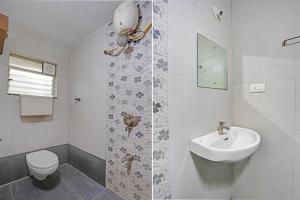 a white bathroom with a sink and a toilet at Collection O Baner Hillview Pune Formerly Siri Lodge in Méribel Village