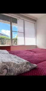 a bedroom with a bed and a large window at Budget-friendly room near Sunshine Station to CBD in Sunshine
