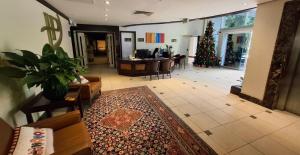 a living room with a christmas tree in the background at Privilege Apart hotel Mountain Village in Canela