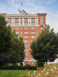 a building with an american flag on top of it at The Huntington Hotel in San Francisco