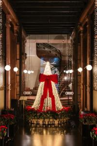 a dress in a window with a red bow at Umbral, Curio Collection By Hilton in Mexico City