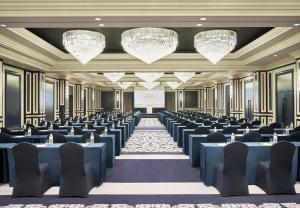 a conference room with blue tables and chairs at Grand Josun Hill Suite in Seogwipo +46 photos