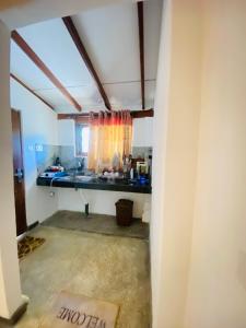 a room with a sink and a window at Mountain Peak Homestay Hiriketiya in Dickwella