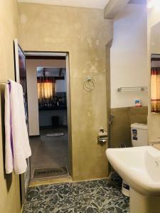 a bathroom with a sink and a shower and a toilet at Mountain Peak Homestay Hiriketiya in Dickwella +34 photos