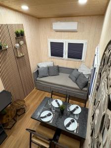 a small living room with a couch and a table at KE-Tiny- Siedlung Haus Paulchen in Oerlenbach
