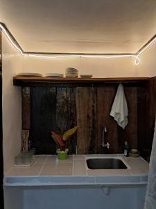 a kitchen with a sink and a counter top at Charity Pension House in San Vicente