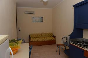 a living room with a couch in the corner of a room at Casa Vacanze Oasi Felicita in Nova Siri Marina