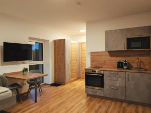 a kitchen with a table and a counter top at Pani's Gästezimmer in Kleinraming