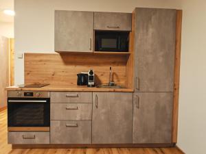 a kitchen with a sink and a microwave at Pani's Gästezimmer in Unterwald +5 photos