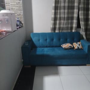 a blue couch sitting in a room at Mikes apartment in Mombasa
