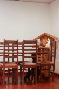 a room with two wooden chairs and a desk at White Rose Holiday Resort in Anuradhapura