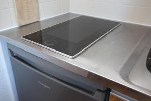 a tablet sitting on top of a counter in a kitchen at Studio 1 chambre, pied des pistes 24 m2 au calme in Risoul