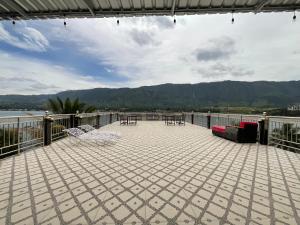 a patio with tables and chairs on a balcony at Penginapan Mafir in Tuk Tuk +46 photos