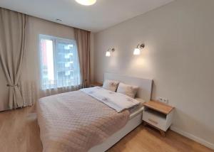 Ένα ή περισσότερα κρεβάτια σε δωμάτιο στο Apart-hotel Magestic EVN Airport