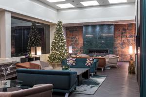 a lobby with a christmas tree and couches at Mercure Palanga Vanagupe Resort & SPA in Palanga