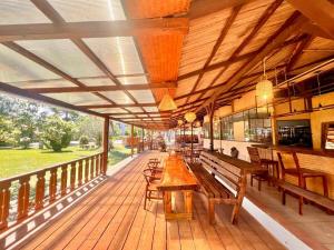 a porch with benches and tables on a deck at Bazaar Square Lodges in Grand-Baie