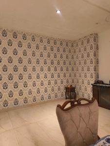 a living room with a wall with a wallpaper at Quiet Haven in Panchkula
