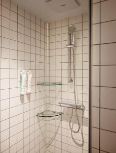 a bathroom with a shower with a shower head at Yeouido Park Hotel in Seoul