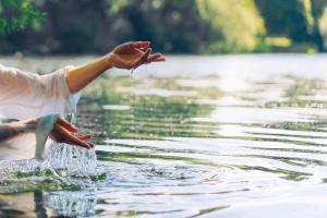 a person washing their hands in a body of water at Alila Mayakoba in Playa del Carmen