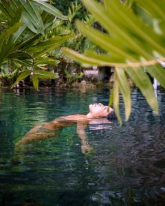a person swimming in a body of water at Alila Mayakoba in Playa del Carmen