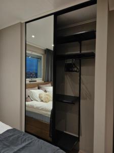 a bedroom with a bed and a large glass closet at ArticLoft Kemi in Kemi +41 photos