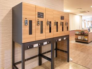 a display of cell phones on a wall in a room at Comfort Hotel Hachinohe in Hachinohe