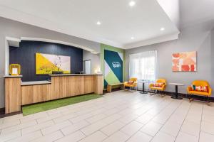 a waiting room at a hospital with orange chairs at Spark by Hilton La Grange in La Grange
