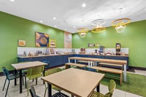 a fast food restaurant with tables and chairs at Spark by Hilton La Grange in La Grange