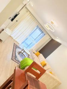 a living room with a couch and a window at Ww homes 2bedroom Apartment in Nairobi