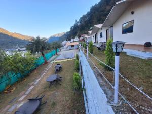 a fence with surfboards on the ground next to a house at Valley King Resort in Rishīkesh