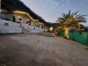 a building with christmas lights on the side of it at Valley King Resort in Rishīkesh