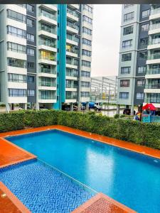 a blue swimming pool in front of some tall buildings at Ww homes 2bedroom Apartment in Nairobi