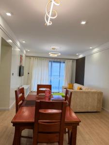 a living room with a table and a couch at Ww homes 2bedroom Apartment in Nairobi