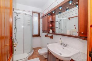a bathroom with a sink and a toilet and a shower at Chicca Di Francesca- Santa Teresa in Santa Teresa Gallura +45 photos