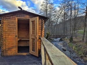 a wooden out house with a wooden door on a bridge at Cabana Victor in Sighetu Marmaţiei +103 photos