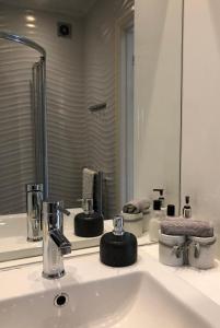 a bathroom with a sink and a mirror at The Oaks A private room in our home With its own entrance with internal doors locked More suited to quieter guests wanting a peaceful stay in Consett +26 photos