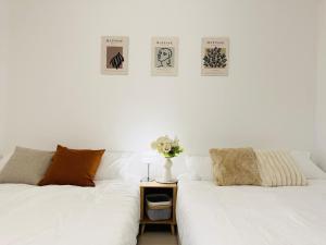 two white beds sitting next to each other in a room at Won-Stay in Samgong