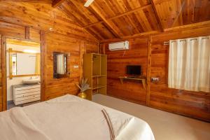 a bedroom with a bed in a wooden cabin at BOHOA Beach Resort Palolem in Palolem +21 photos