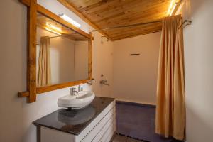 a bathroom with a sink and a mirror at BOHOA Beach Resort Palolem in Palolem