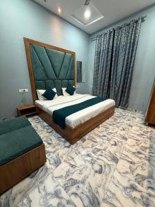a bedroom with a large bed and a large rug at Sodhi Residency in Amritsar