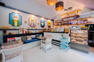 a room with a bakery with a counter and tables at Perennial Resort in Nai Yang Beach